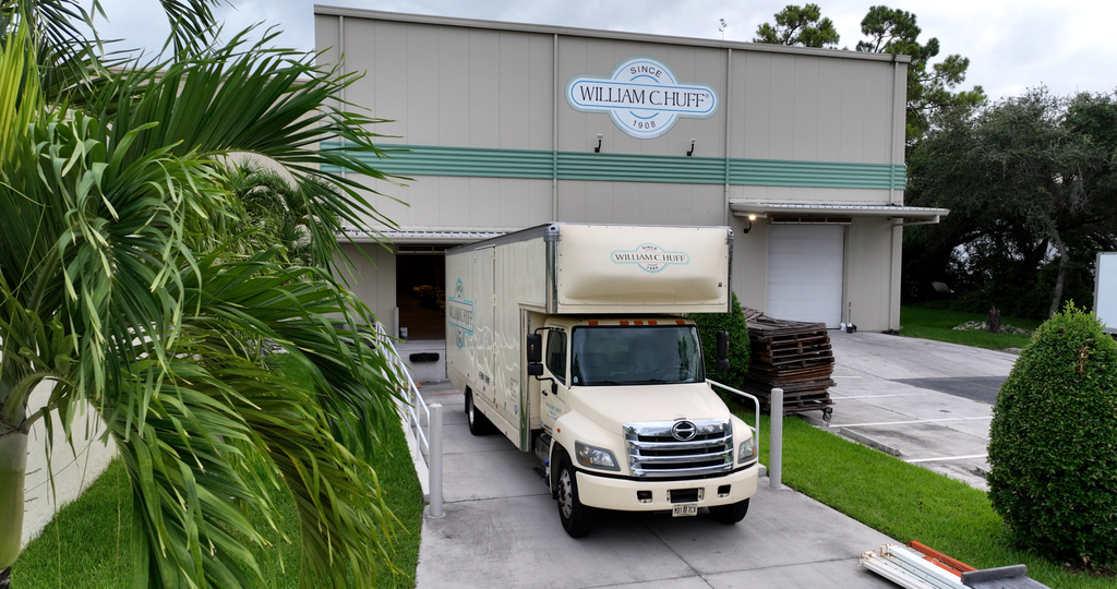 William C. Huff moving truck parked at a loading dock in front of a large storage warehouse