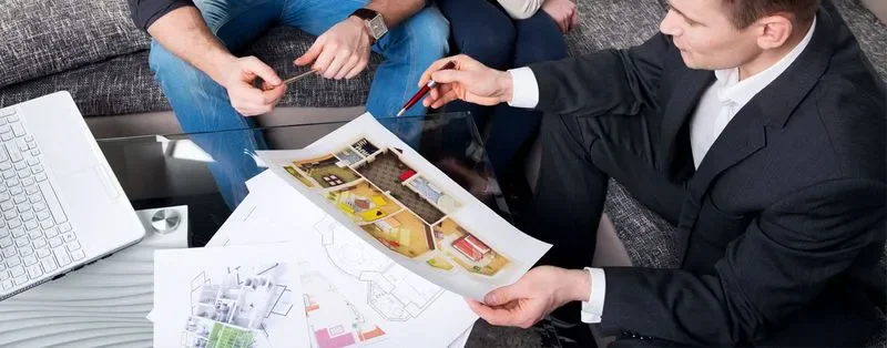 Design professionals reviewing interior renderings and plans together
