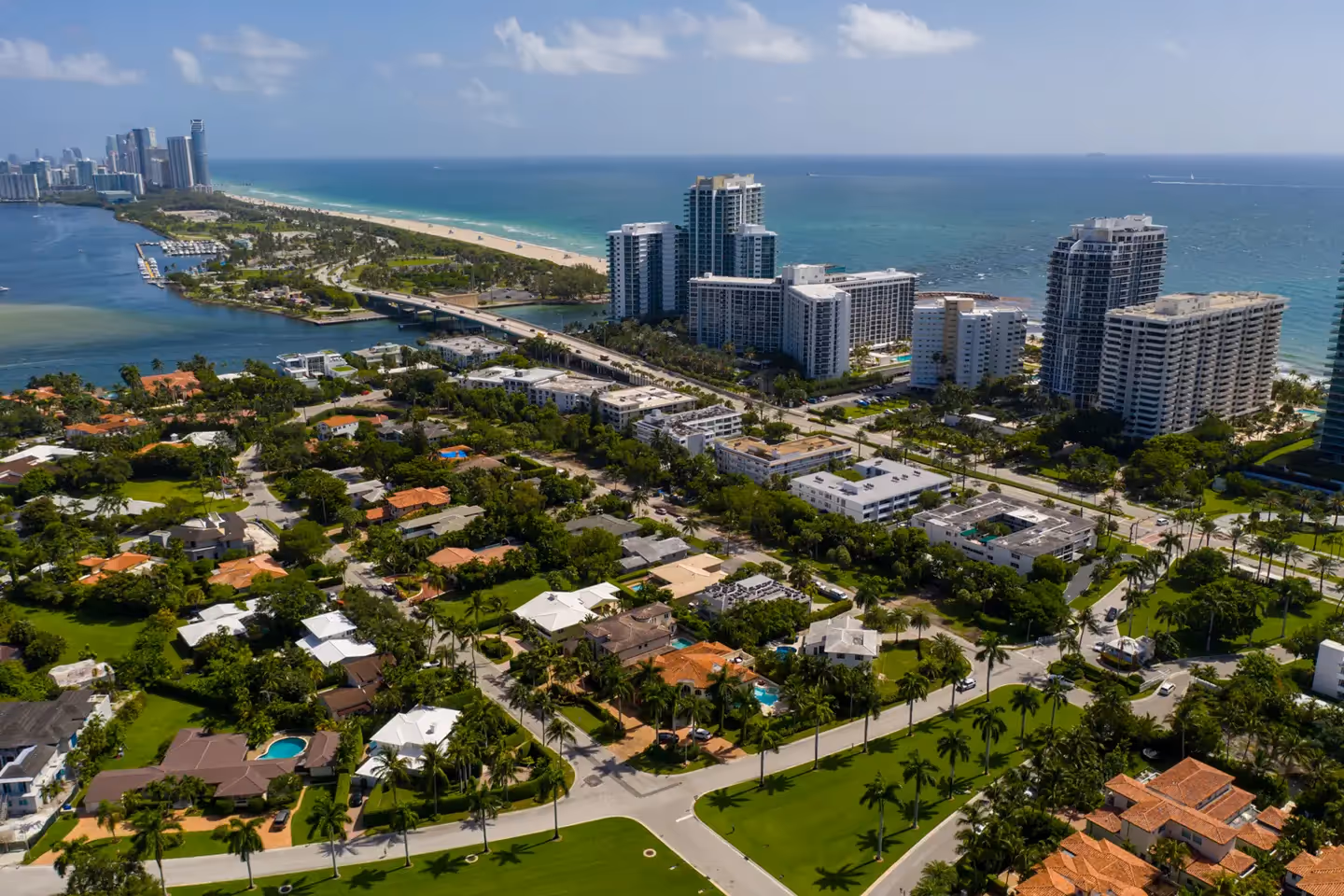 Aerial view of luxury coastal properties and high-rise buildings along the waterfront in Miami