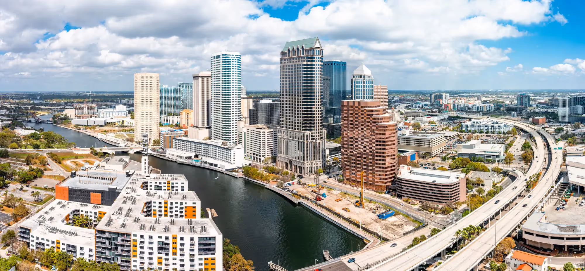 Aerial view of the downtown Tampa skyline and waterfront at sunset with the Hillsborough River in Florida