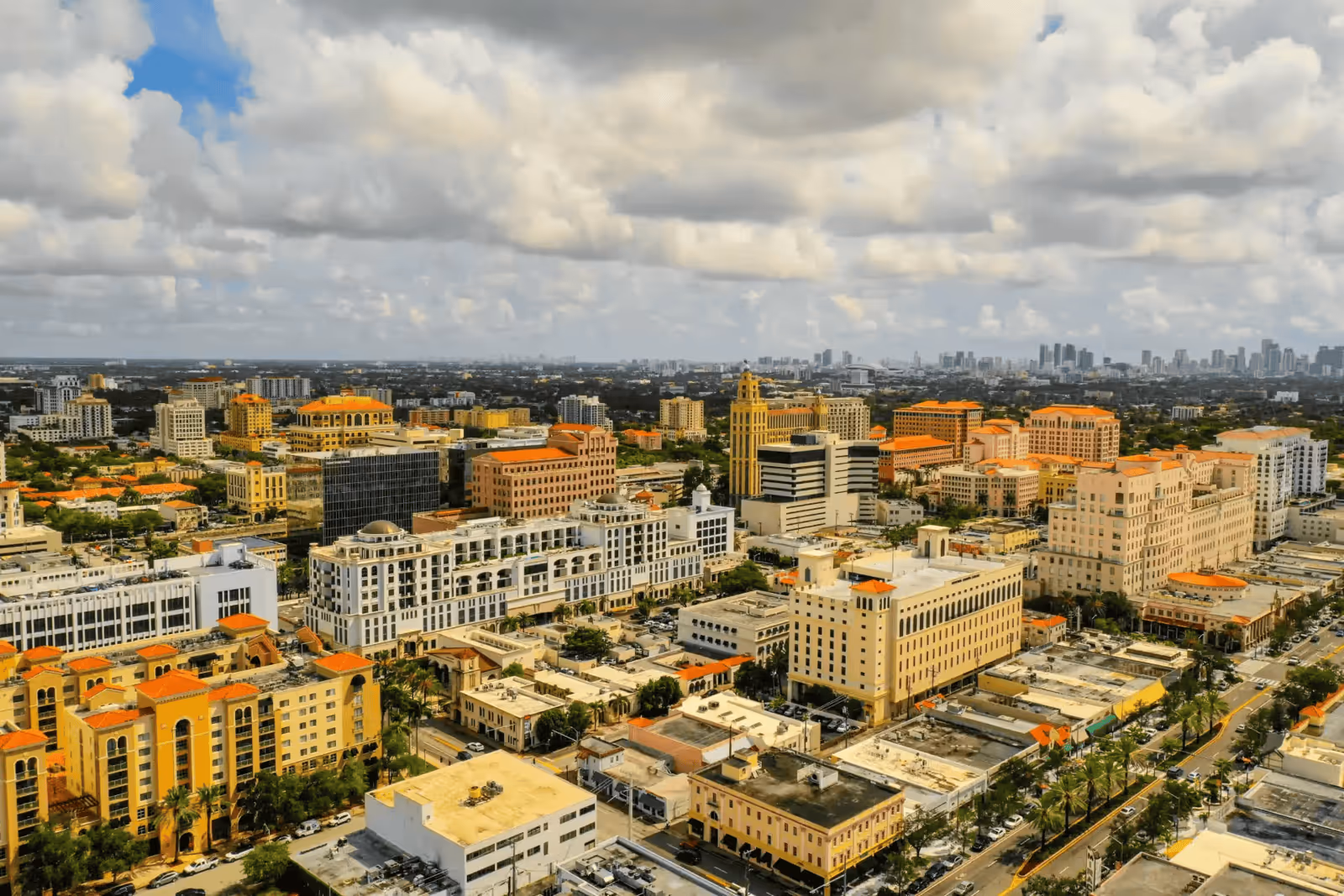 Aerial city view of Coral Gables, Florida, featuring Mediterranean-style architecture and office buildings