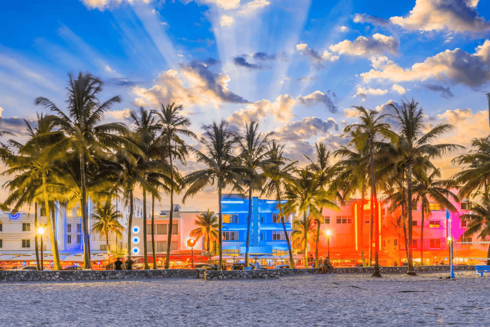 Ocean Drive Miami Beach at sunset with Art Deco buildings and palm trees