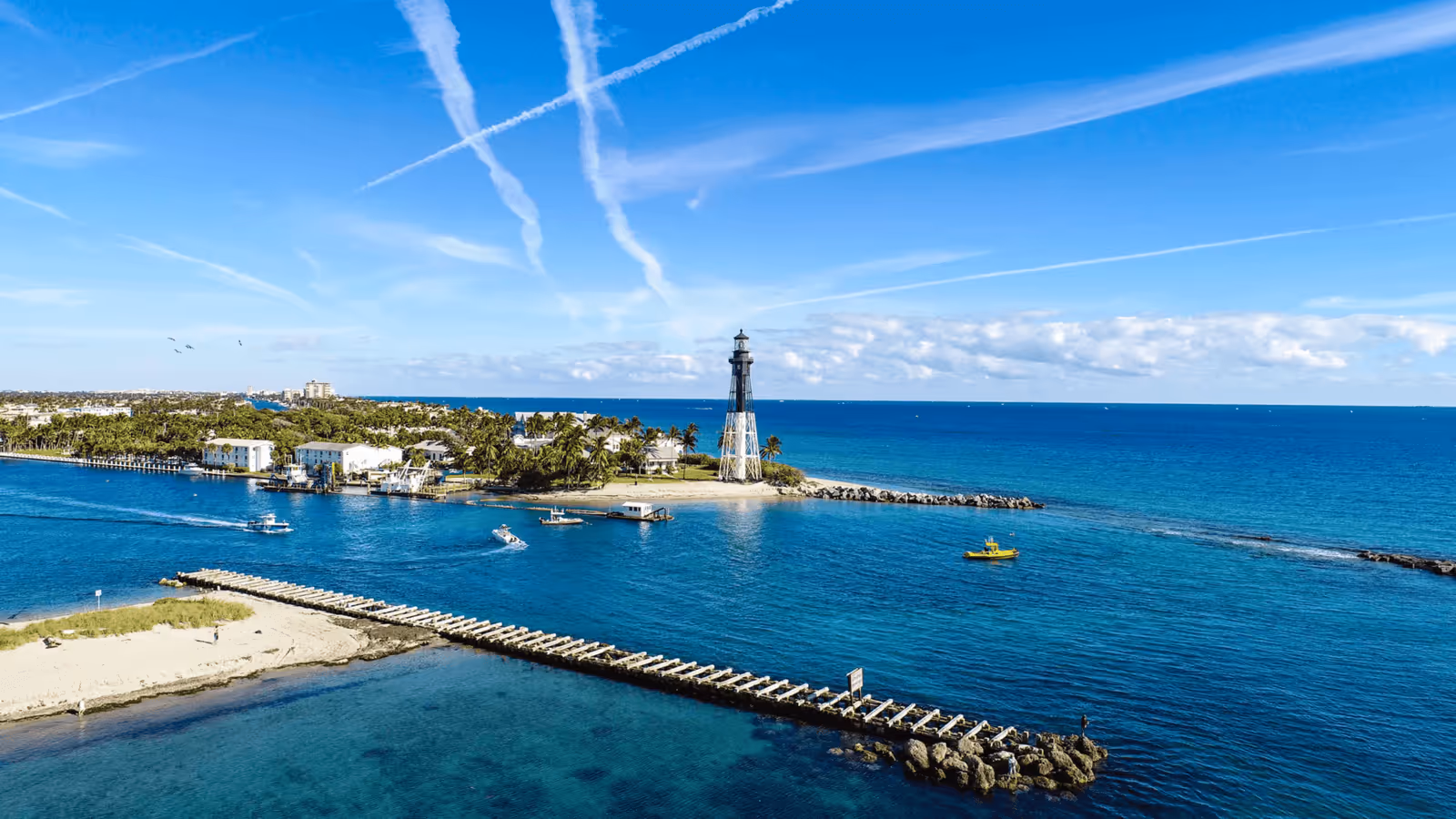 Aerial view of Hillsboro Inlet Lighthouse and the turquoise waters of Hillsboro Beach in Florida
