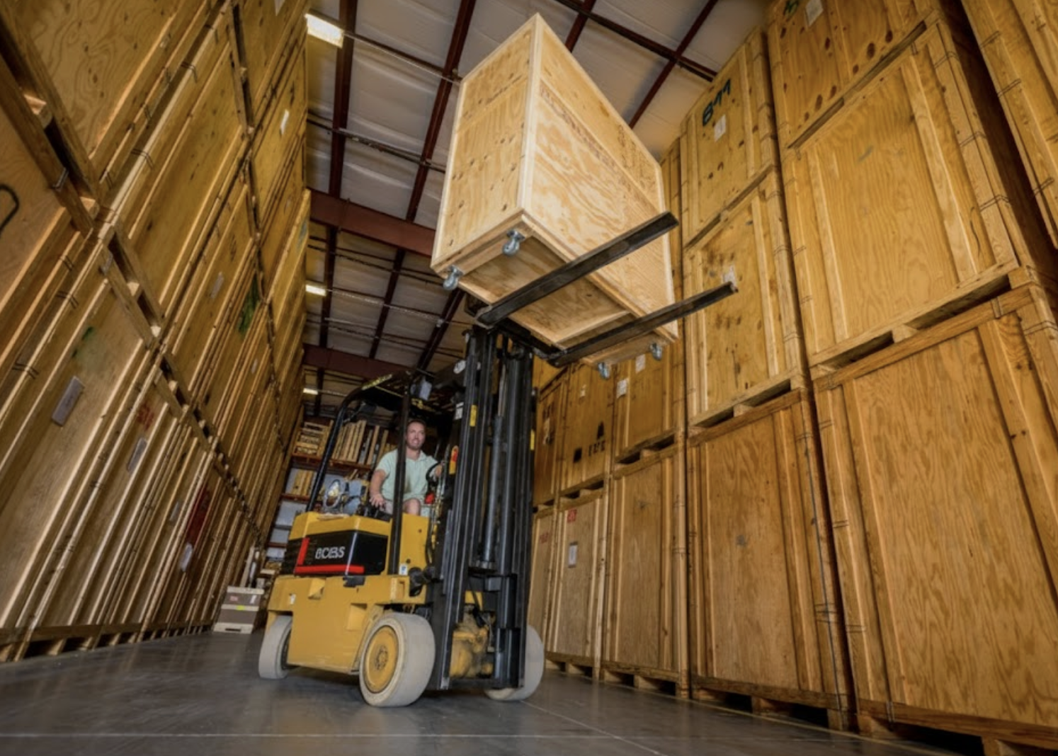 A professional William C. Huff mover carefully handling a protective-wrapped item during a white-glove relocation