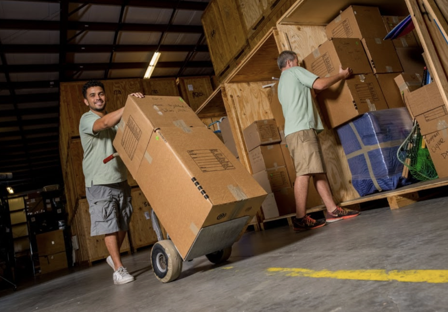 A secure warehouse facility featuring stacked wooden storage vaults for climate-controlled inventory management
