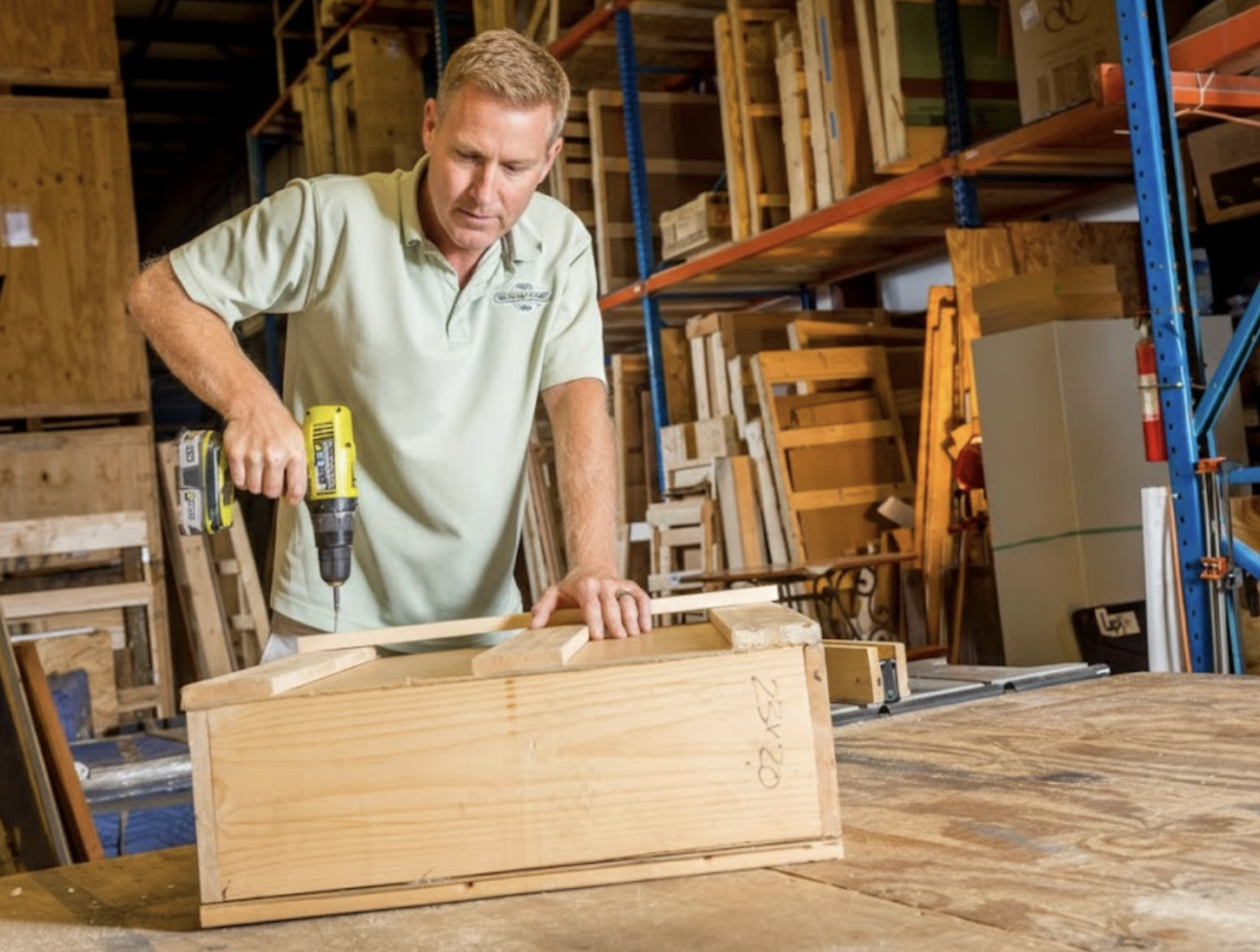 A professional mover building a custom wooden crate for secure transport and storage of high-value items