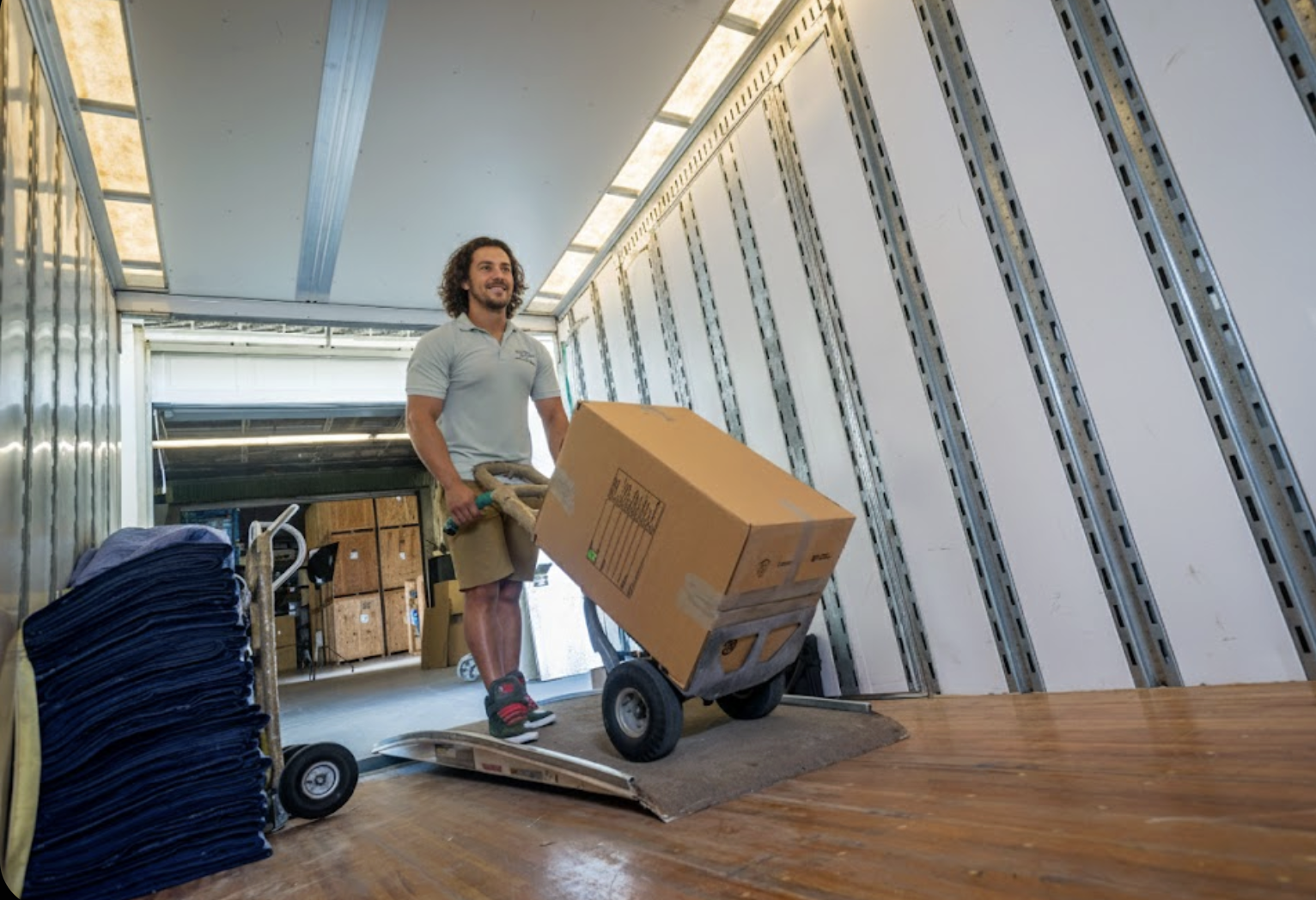 Professional William C. Huff movers loading a climate-controlled moving truck at a luxury estate