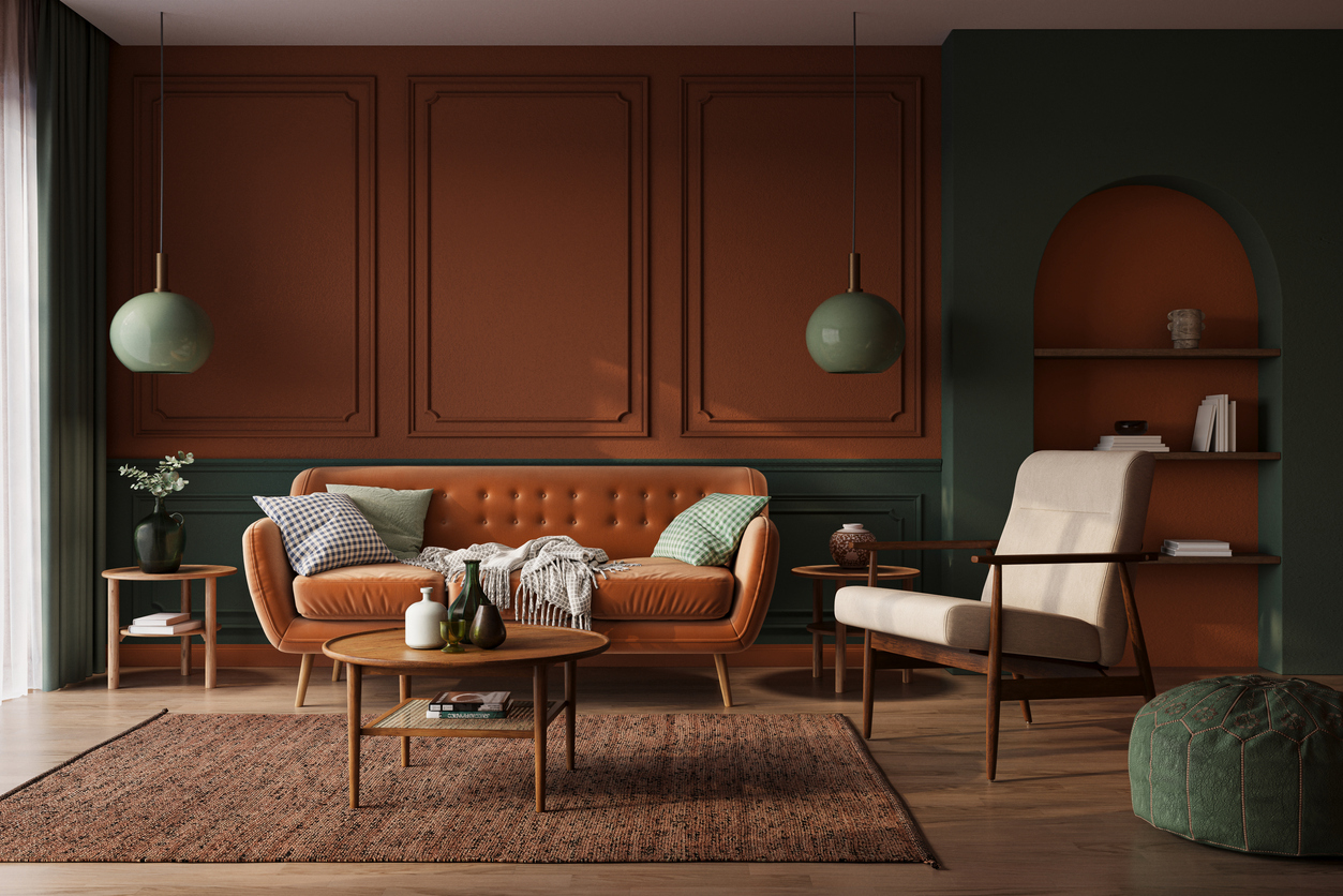 Mid-century modern living room featuring an orange leather sofa, green accents, and wood furniture
